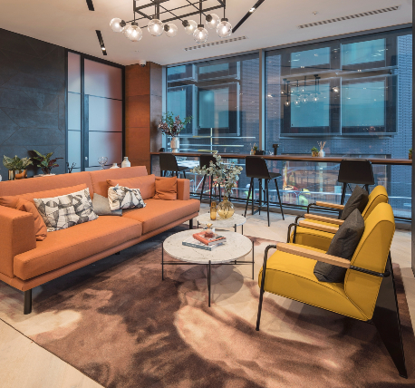 Commercial office reception waiting area, with comfortable seating and shelf running the length of the window