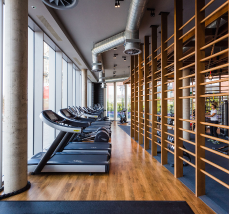 Gym showing equipment and feature timber partition and exposed ductwork