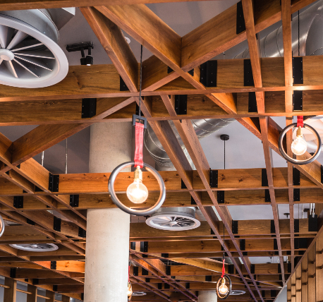 Gym ceiling with bespoke timber rafts and drop lights