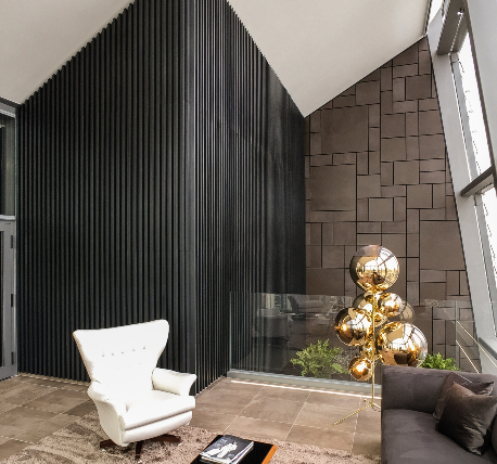 Penthouse with black metal clad feature walls, glass balustrade and high back chair