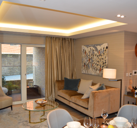 Lounge area of an apartment showing doors leading to balcony