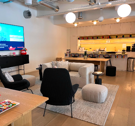 Office break area with sofas and kitchen