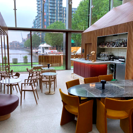 Lounge bar with seating area, walls decorated with timber cladding