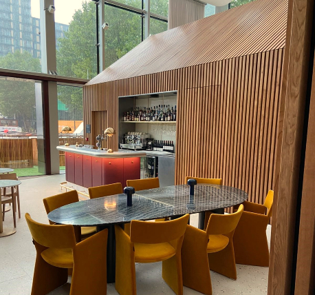 Lounge bar with seating area, decorated with timber cladding