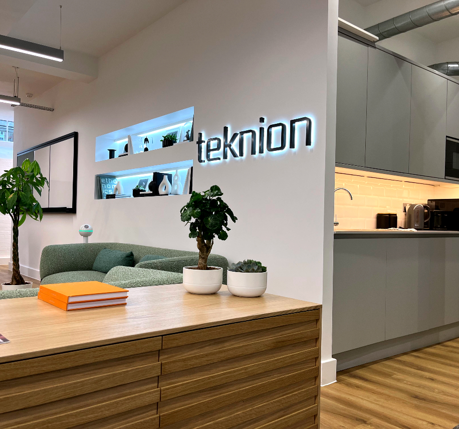 Office with kitchen, seating area and backlit signage