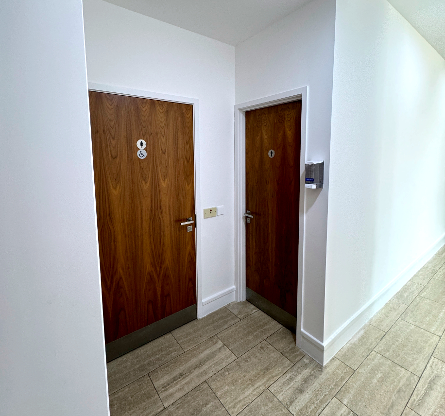 Toilet entry doors with signage